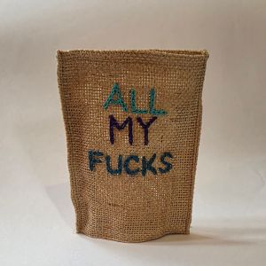 A small hessian bag with "All My Fucks" embroidered on it