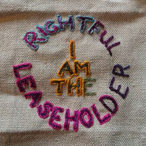 "I Am The Rightful Leasholder" embroidered in multicoloured thread on tabby weave linen